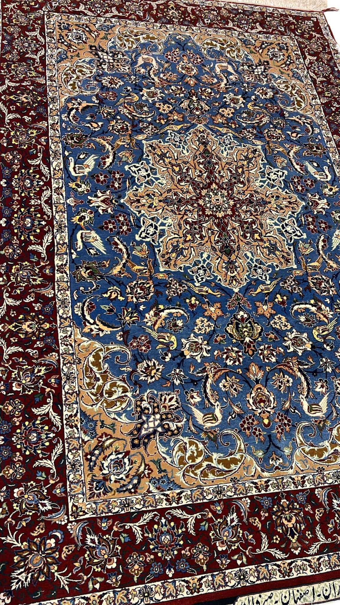 "Luxurious Seirafian wool and silk rug featuring detailed floral designs, natural-dyed in blue and beige, handwoven in Isfahan, Iran."